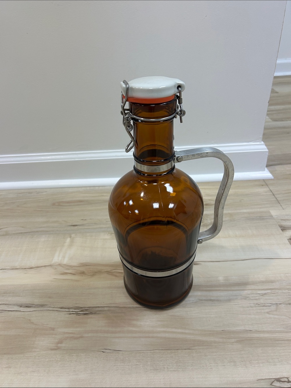 This is a vintage Muster Geschützt 2-liter amber glass beer growler originating